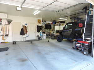 Garage featuring a workshop area and a garage door opener