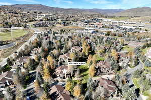 Aerial view of property's location featuring mountains and nearby suburban area