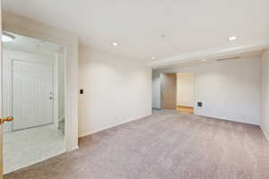 Spare room with recessed lighting and light colored carpet