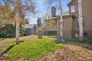 Back of house featuring a chimney and a deck