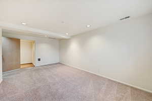 Unfurnished room featuring recessed lighting and light colored carpet