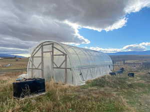 View of greenhouse featuring a rural view