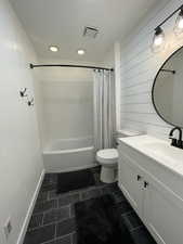 Full bathroom with shower / bath combo, vanity, and recessed lighting