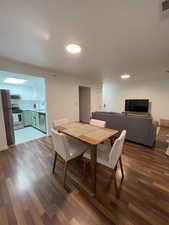 Dining area with dark wood-style floors