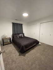 Bedroom featuring carpet floors and two closets