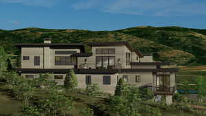 Rear view of property featuring a balcony, a chimney, and a mountain view