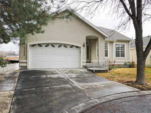 Single story home with stucco siding, concrete driveway, a garage, and roof with shingles