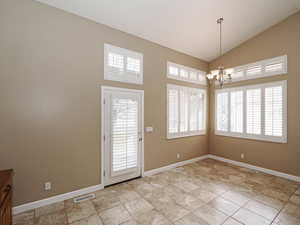 Entrance foyer featuring a chandelier and lofted ceiling