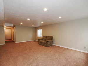 Unfurnished room with light colored carpet and recessed lighting