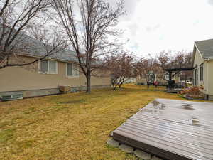 View of green lawn with a deck