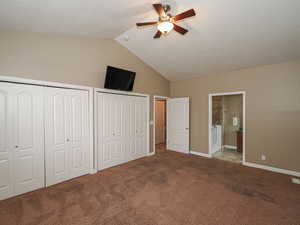 Unfurnished bedroom with multiple closets, connected bathroom, carpet flooring, and ceiling fan