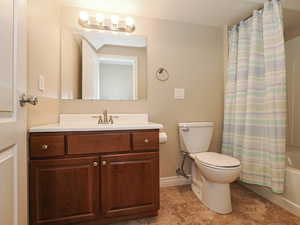 Full bath featuring shower / bath combo and vanity