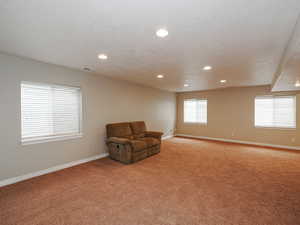 Unfurnished room with light colored carpet and recessed lighting