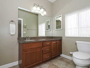 Full bathroom featuring vanity and toilet