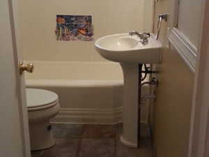 Bathroom with a shower and tile walls