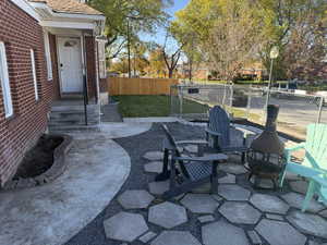 View of patio with an outdoor fire pit