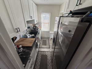 Washroom featuring baseboards and dark tile patterned floors