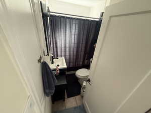 Full bathroom featuring vanity, a shower with curtain, and tile patterned flooring