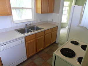 Kitchen with white appliances and light countertops