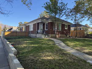 Bungalow-style house with brick siding
