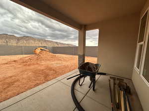 Fenced backyard with a mountain view and a patio area