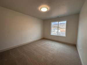 Unfurnished room featuring light colored carpet and baseboards