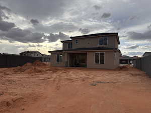 Rear view of house with a patio and stucco siding