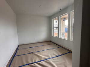 Unfurnished room featuring baseboards