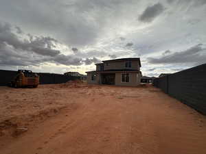 Rear view of house featuring a fenced backyard, a patio area, and stucco siding