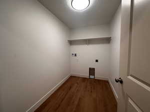 Laundry room featuring dark wood-type flooring, washer hookup, and electric dryer hookup
