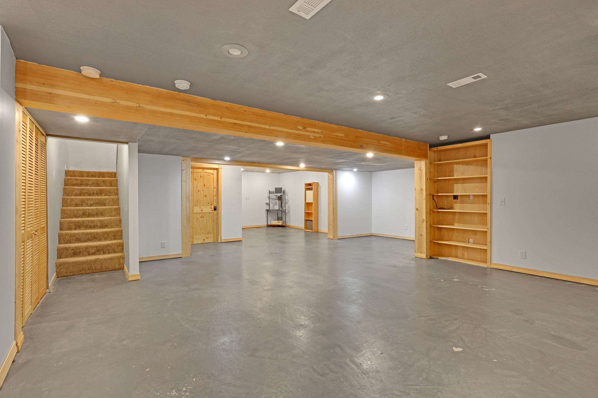 Finished below grade area featuring recessed lighting and stairs