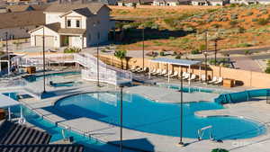 Community pool with a patio and a residential view