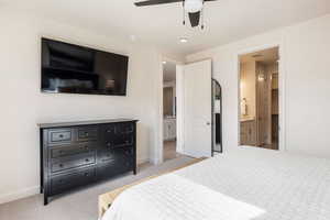 Bedroom with light colored carpet, recessed lighting, connected bathroom, and a ceiling fan