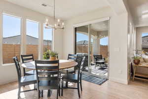 Dining space featuring light wood-style floors and a chandelier