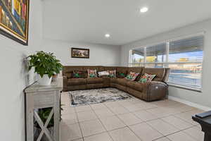 Living area featuring light tile patterned floors and recessed lighting