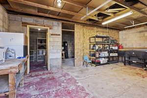 Misc room with concrete floors and a workshop area