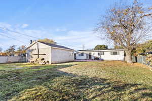 Back of house with a patio and concrete block siding