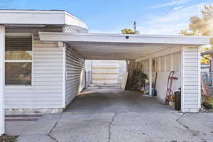 View of parking featuring an attached carport