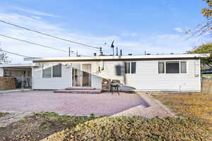 Rear view of property featuring a patio area