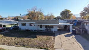 Ranch-style house with driveway and roof with shingles