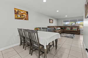 Dining space featuring light tile patterned floors and recessed lighting