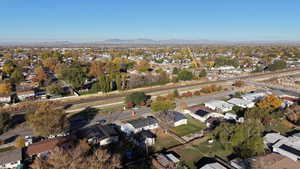 Aerial overview of property's location with nearby suburban area and a mountain backdrop