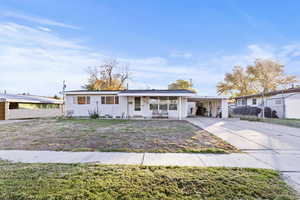 Ranch-style house with a carport and concrete driveway