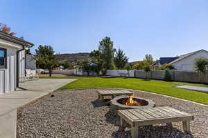 Fenced backyard with a patio area and an outdoor fire pit