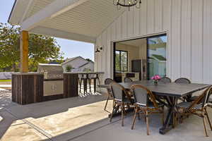 View of patio with exterior kitchen and outdoor dining area