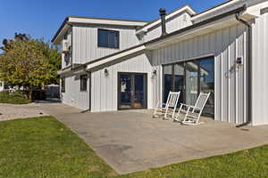Rear view of house featuring a lawn