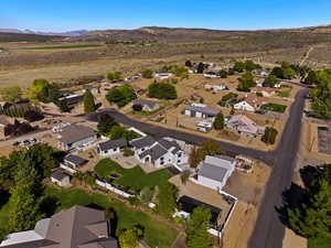 Aerial overview of property's location featuring nearby suburban area and a mountainous background