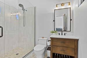 Full bathroom with a stall shower and vanity