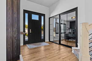 Entrance foyer with stairway and wood finished floors