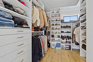 Spacious closet featuring light wood-type flooring